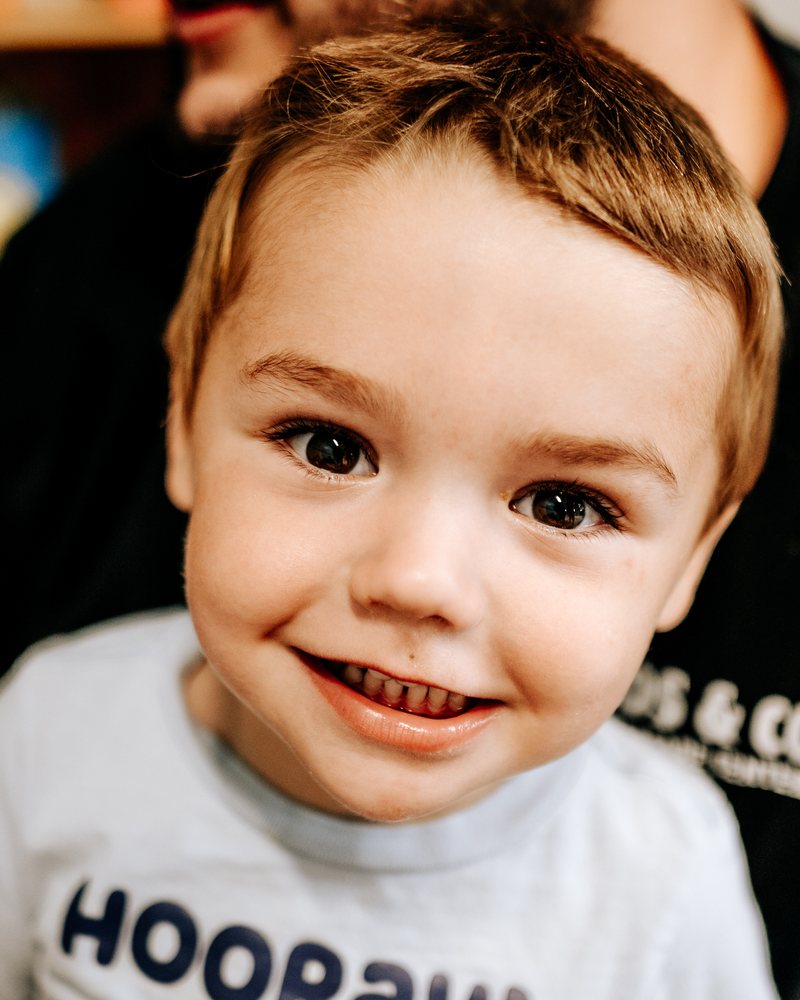 A boy grinning at the camera up close