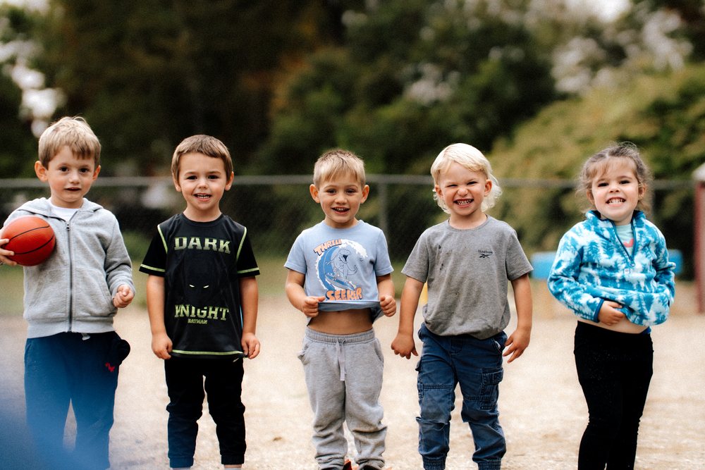 Five children lined up on the playground